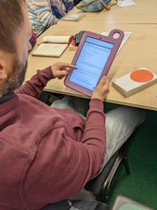 Group of retired people use the Hublet tablets to research book reviews during their sessions.